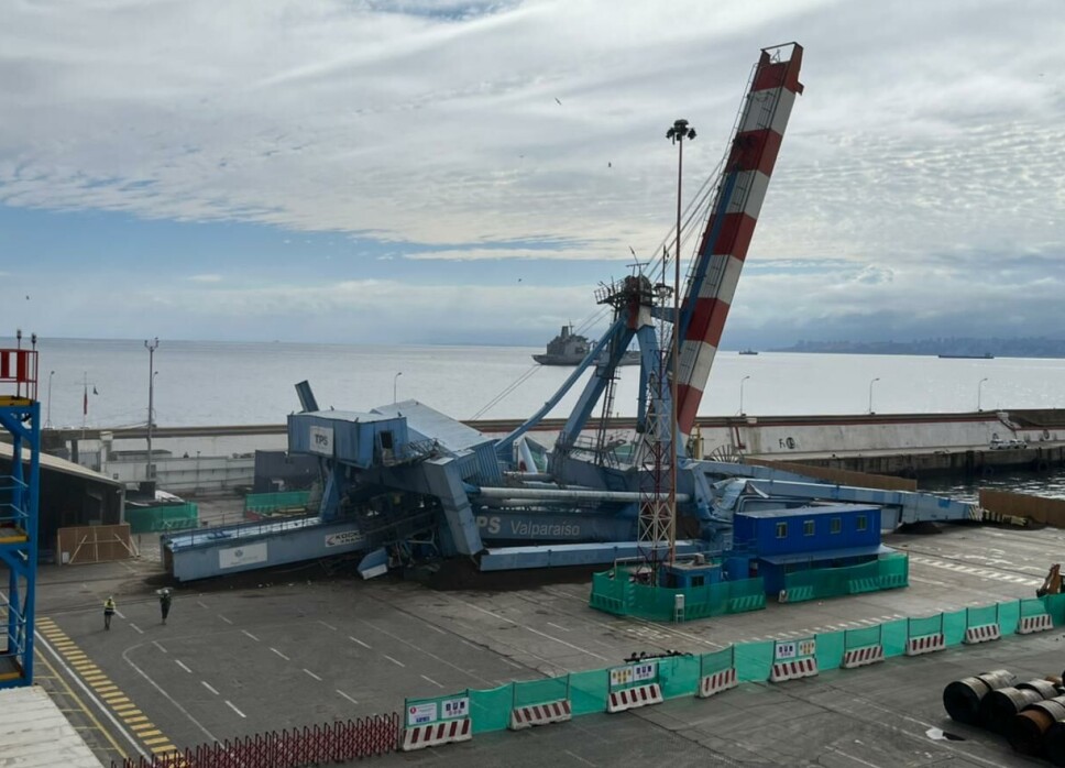 La antigua grúa, con 20 años de uso en Valparaíso, reposa en el suelo después de colapsar en forma programada con anticipación.